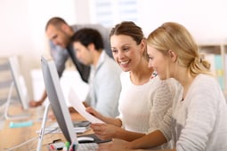 College girls working in front of desktop College girls working in front of desktop